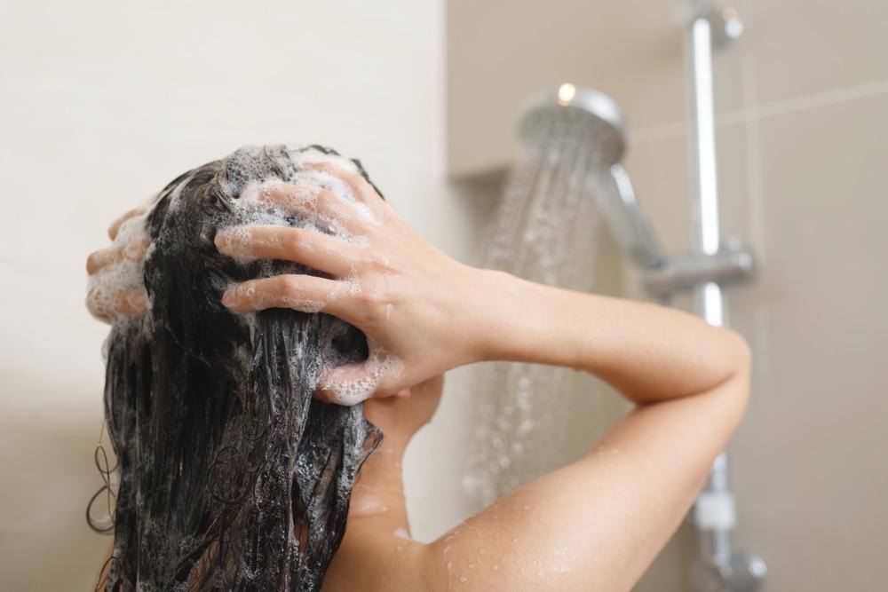 A woman washing her hair in the shower