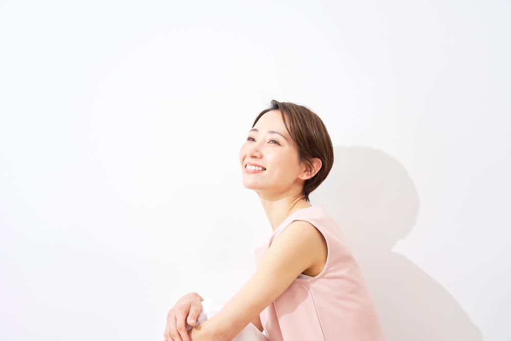 A smiling woman with a short pixie haircut